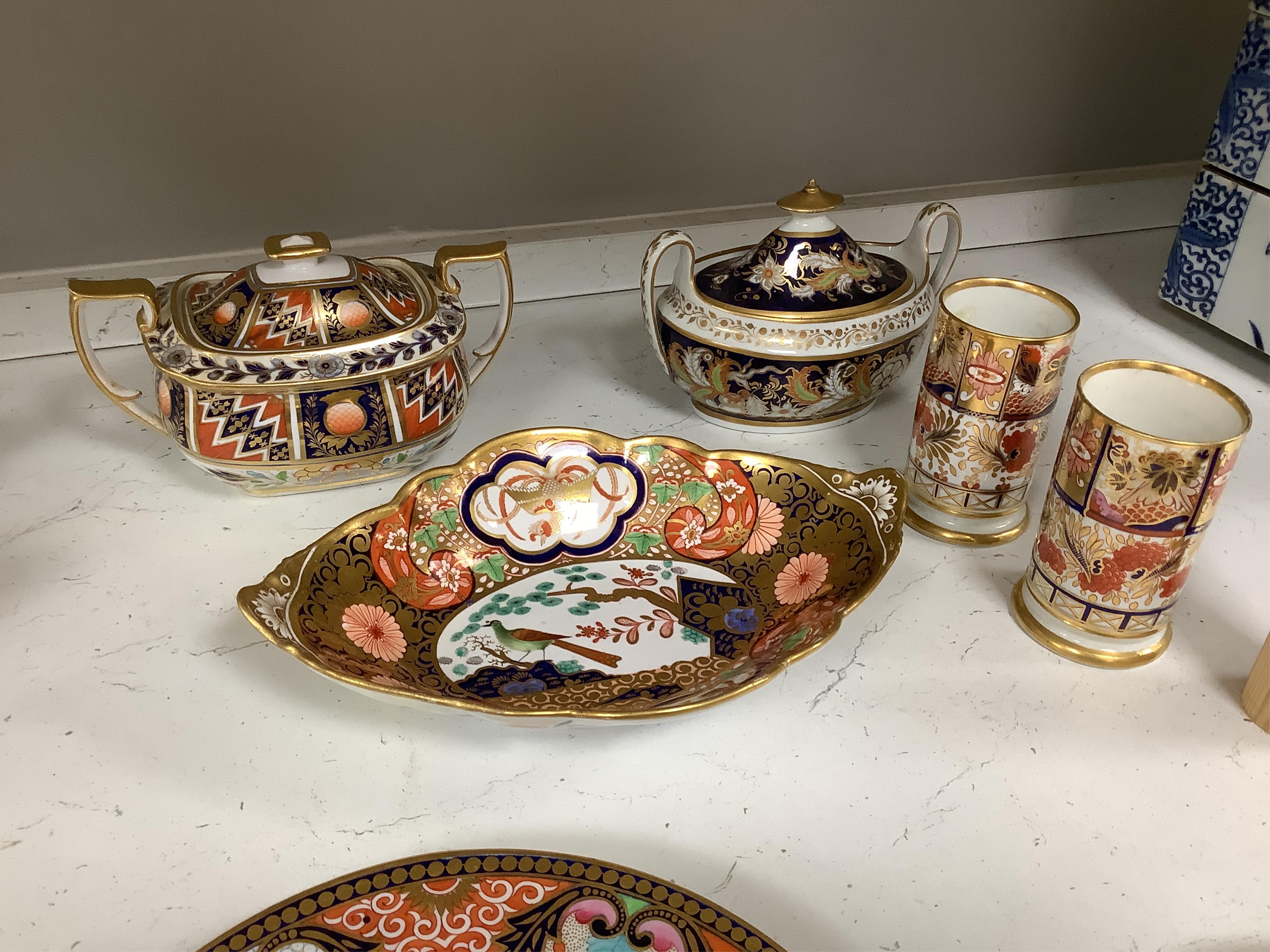 Sixteen mixed items of 1800-1820 English porcelain tableware, to include: three sucriers and covers, an oval ornately decorated dish, four saucer dishes, a candle holder, three spill vases and four saucers